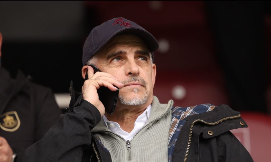 Burnley chairman Alan Pace makes a phone call