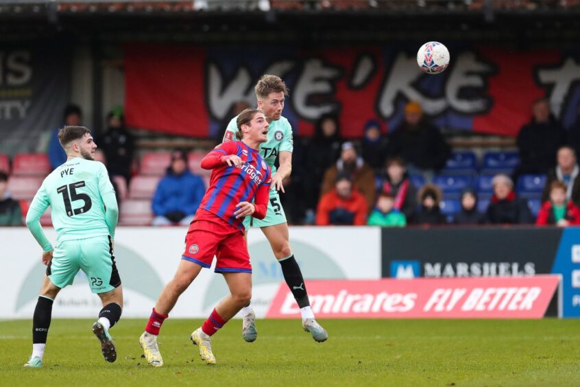 Lorent Tolaj (red) goes for goal for Aldershot.