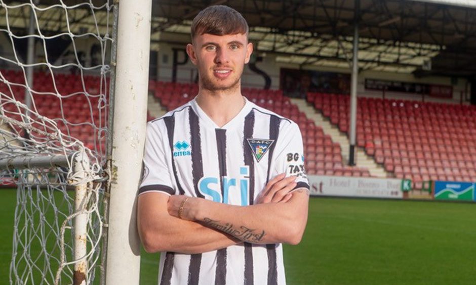New Dunfermline Athletic FC signing Brad Holmes stands with his arms folded at East End Park.