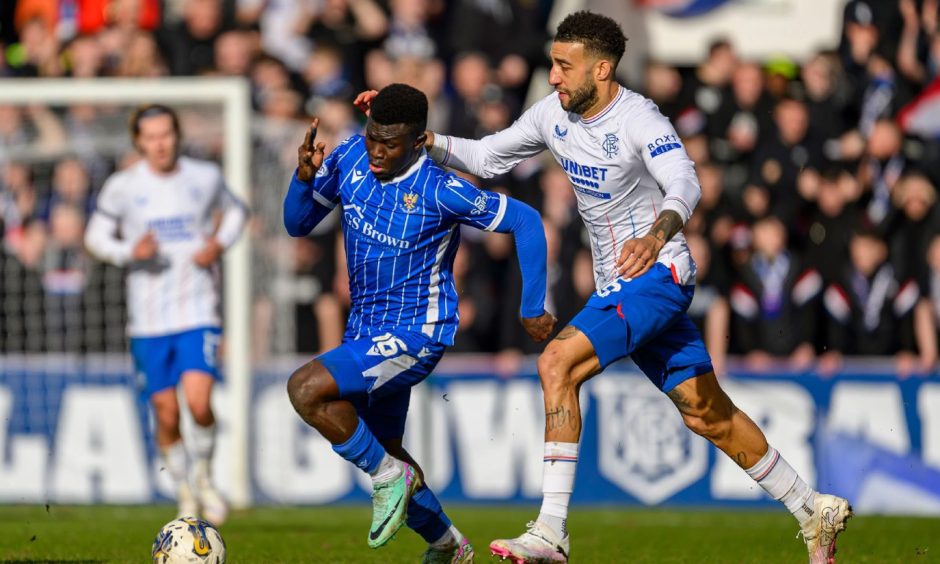 Connor Goldson gets to grips with Adama Sidibeh.