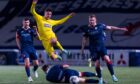 Euan Murray slides into to another challenge as Morton substitute Michael Garrity hurdles over the Raith Rovers defender.