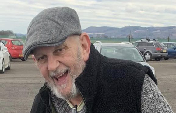 Keith Payne in flat cap, smiling at Errol Sunday Market