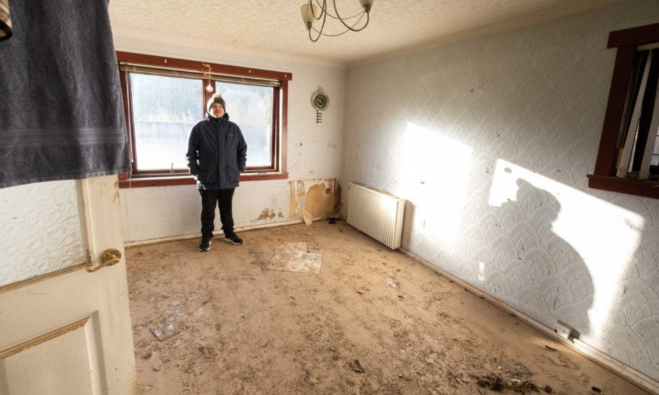 Euan Clark inside his mud-covered River Street flat in the days after Storm Babet. 