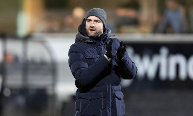Dunfermline Athletic F.C. manager James McPake claps the Pars fans at the end of a game.