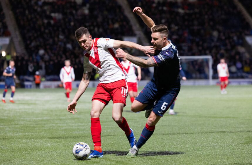 Airdrie match winner Nikolay Todorov holds off Raith Rovers defender Euan Murray.