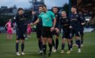 Dundee players dispute a penalty decision against Hearts. Image: SNS