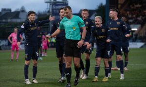 Dundee players dispute a penalty decision against Hearts. Image: SNS