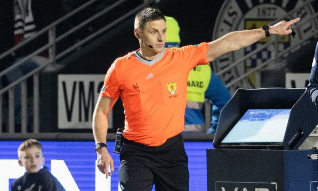 Referee Steven McLean confirms St Mirren's James Bolton is sent off after a VAR check during a cinch Premiership match between St Mirren and Dundee.