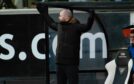 Dunfermline manager James McPake throws his hands in the air in exasperation.