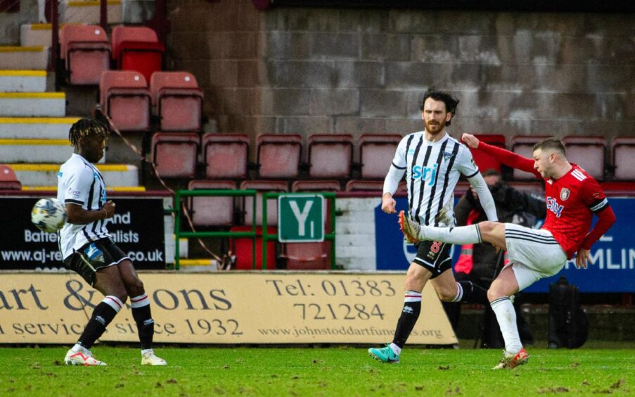 Dom Thomas extends his left leg after curling the ball towards the target for Queen's Park's second goal against Dunfermline.