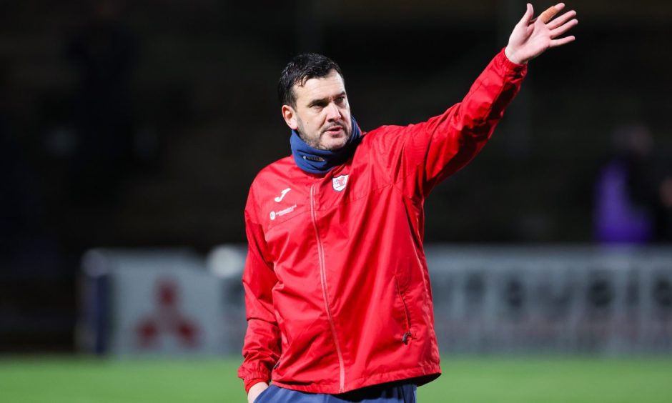 Raith Rovers manager Ian Murray stretches out his left arm in the direction of the fans.