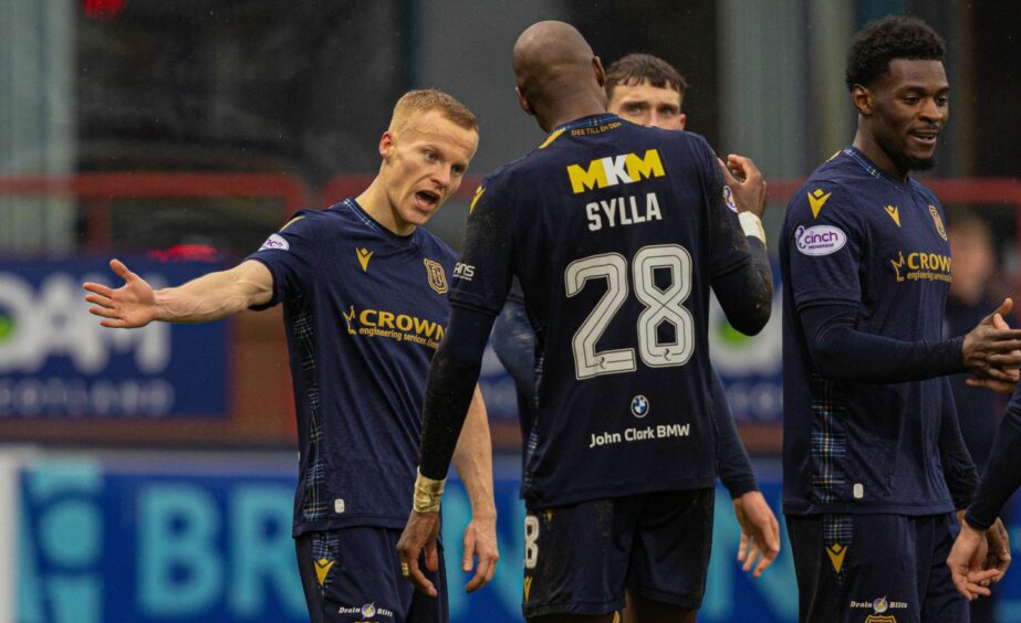 Dundee's Mo Sylla congratulates Scott Tiffoney after Dundee FC went 2-0 up. Image: SNS