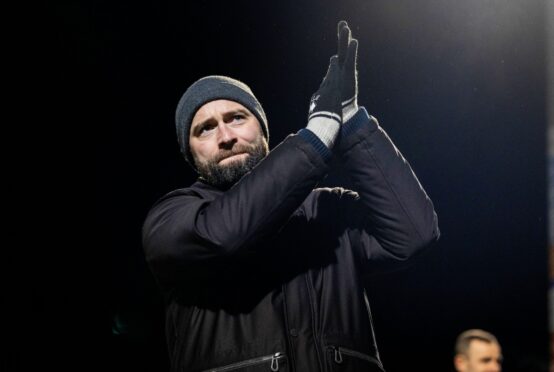 Dunfermline manager James McPake claps the travelling support.