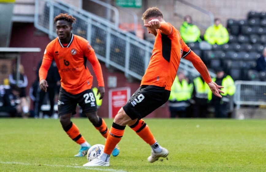 Louis Moult steps up to curl home the equaliser for Dundee United