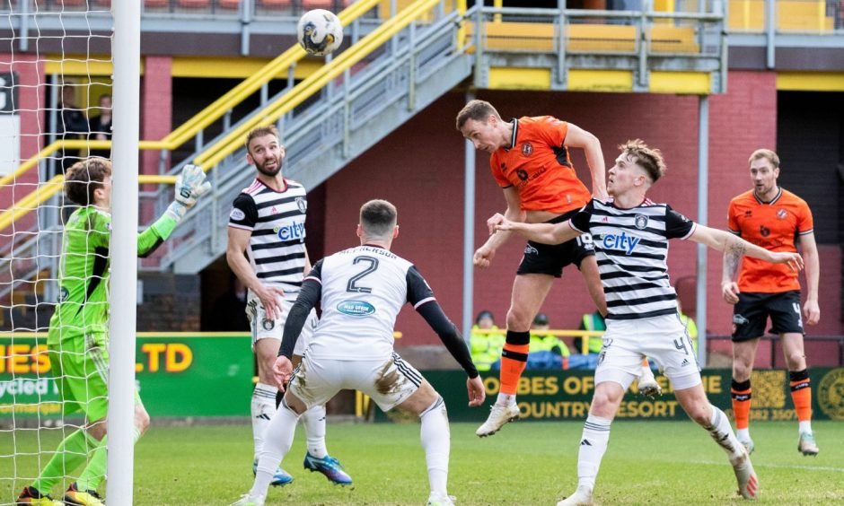 Jordan Tillson heads home his first goal for Dundee United