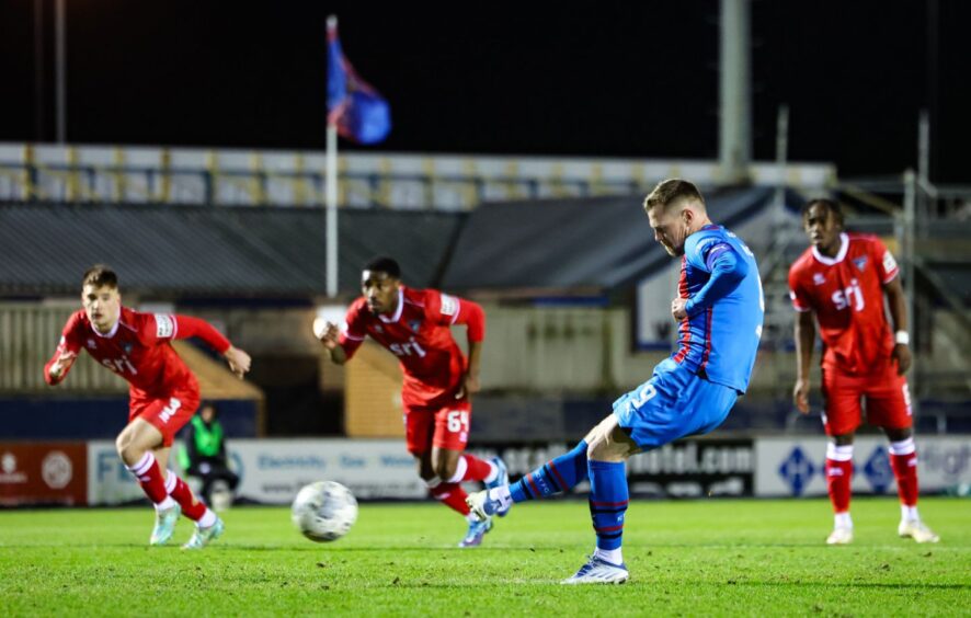 Inverness Caley Thistle striker Billy Mehmet takes his penalty right-footed as a trio of Dunfermline Athletic F.C. players look on.