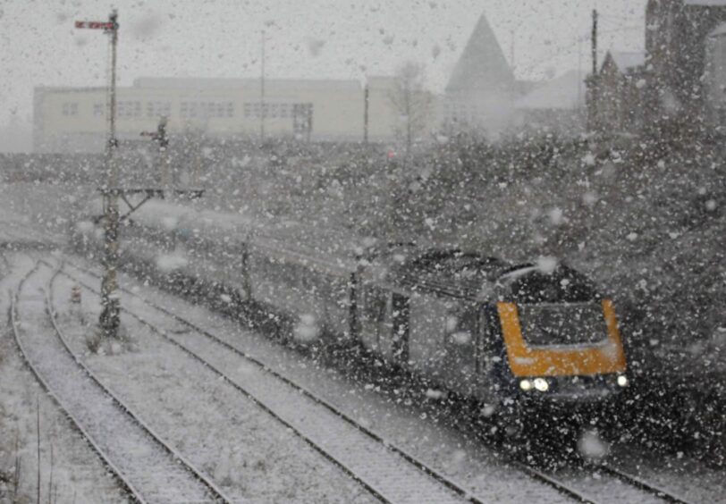 A train on the tracks amid a flurry of snow