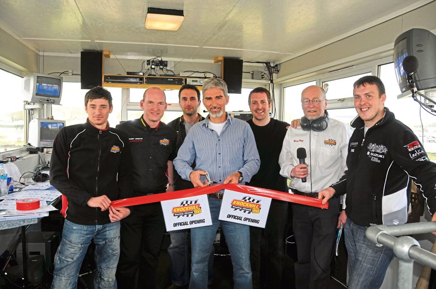 Image shows the team at Knockhill with Damon Hill in the centre of the picture cutting the ribbon for the newly refurbished commentary tower.