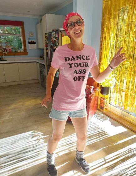 Ali pictured during her kitchen dance fundraiser for Alopecia UK.