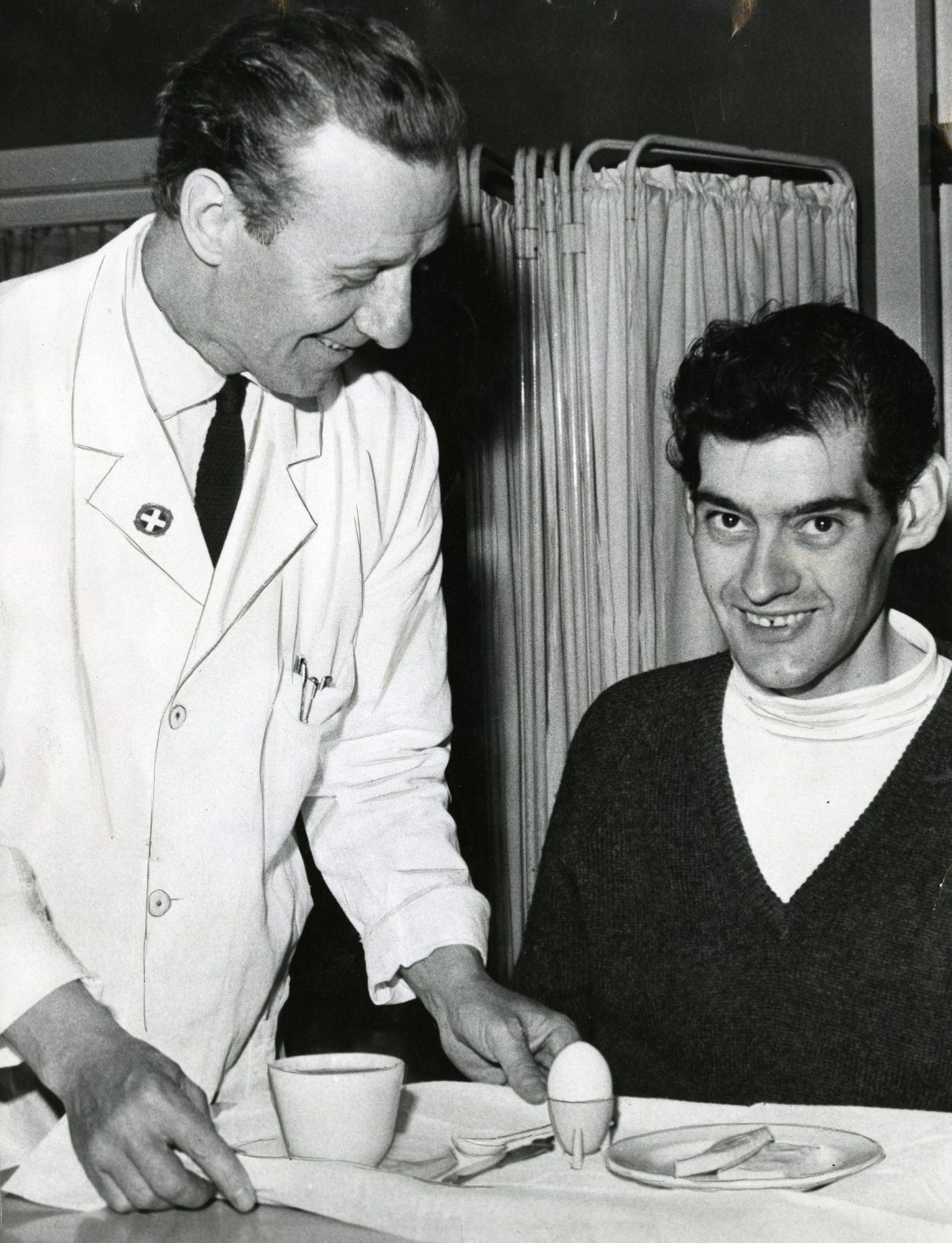 Angus Barbieri in hospital as a smiling doctor puts a tray carrying egg and toast in front of him