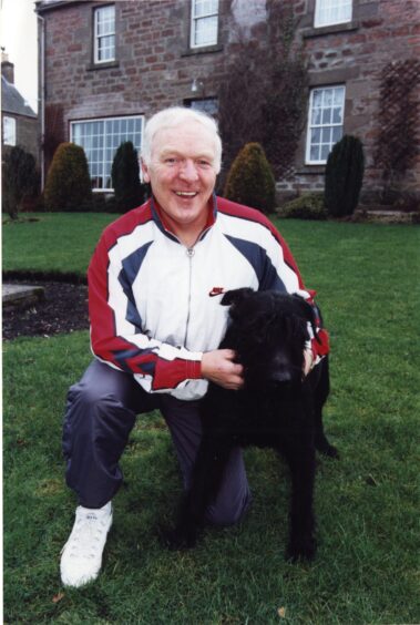 Anderson is all smiles outside his Dunfermline home with his dog in 1996.