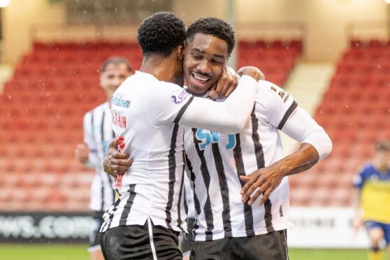 Malachi Fagan-Walcott is hugged by Xavier Benjamin after scoring Dunfermline's goal in the 1-1 draw with Arbroath.