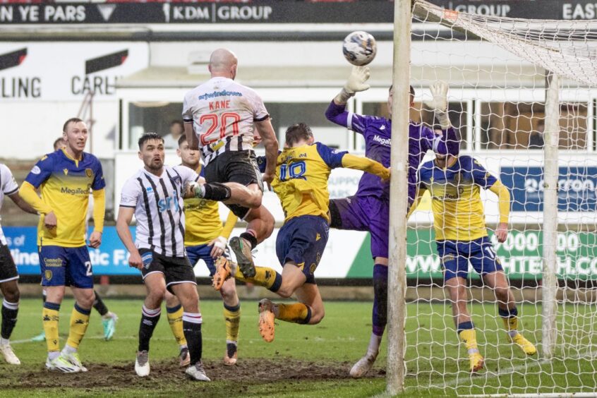 Chris Kane rises high in a crowded penalty box to send a header off the post from point-blank range.