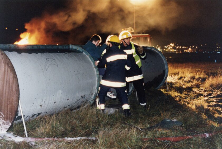 Two firefighters helping a civilian during the 1994 emergency exercise. 