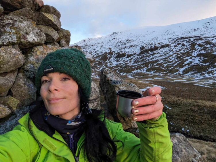 Gayle warms up with a flask of coffee at Bessie's Cairn in Glen Isla. 