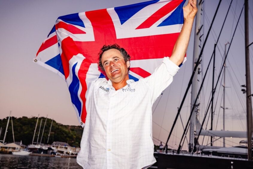 Henry Cheape celebrates in Antiqua after completing his solo row across the Atlantic Ocean.