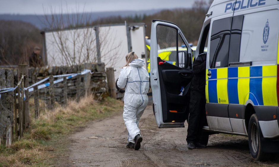 Forensics officers search the scene where Brian Low was murdered. 