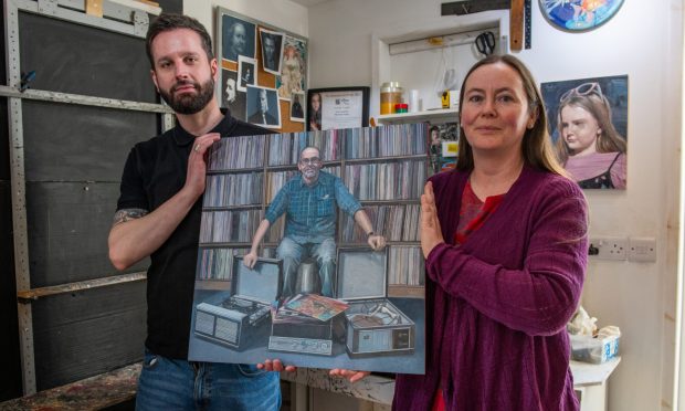 Jenny Brodie and artist Steven Higginson with the portrait of Alastair 'Breeks' Brodie. Image: Kim Cessford/DC Thomson