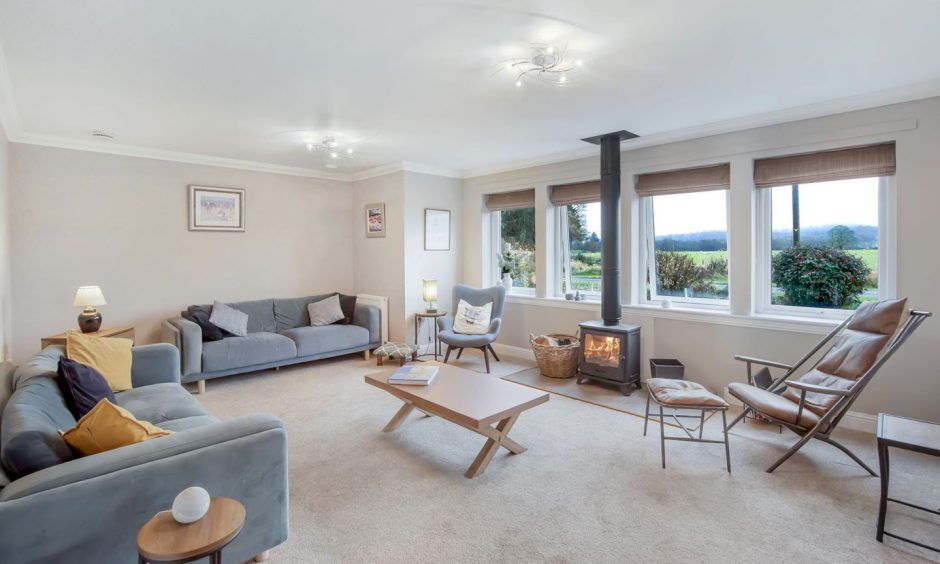 The living room has great views and a wood-burning stove. 