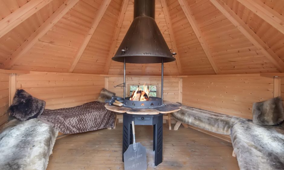 Inside the barbecue hut, which has the grill in the centre and seating around the walls