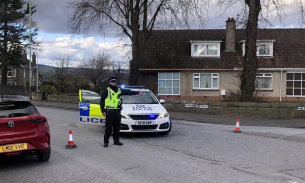 Police closed a section of Strathmartine Road at the junction with Park Road in Dundee on Monday.