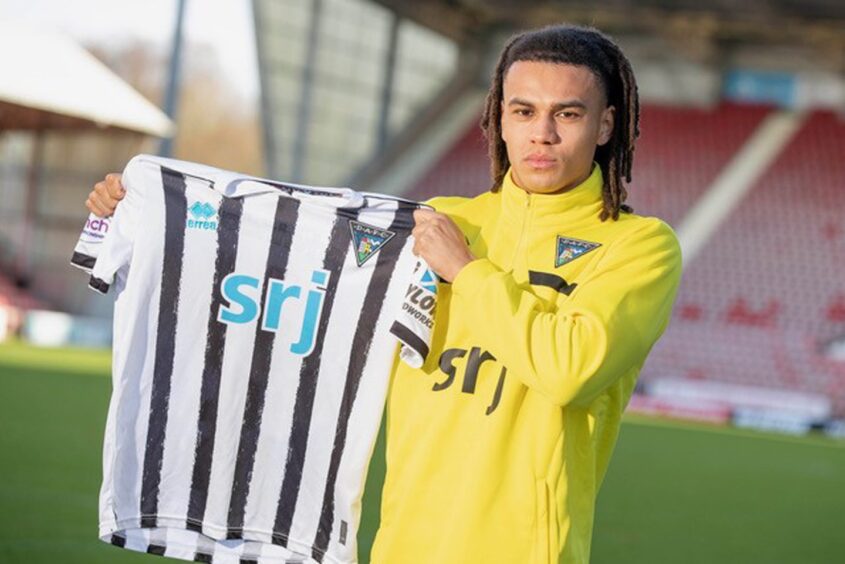 Livingston defender Miles Welch-Hayes holds up a Dunfermline Athletic strip after signing.
