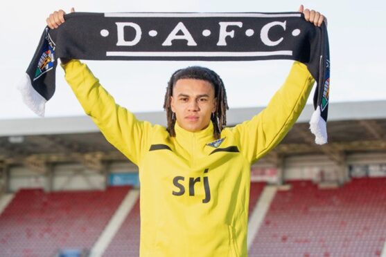Livingston defender Miles Welch-Hayes hold a scarf above his head after signing on loan Dunfermline Athletic F.C.