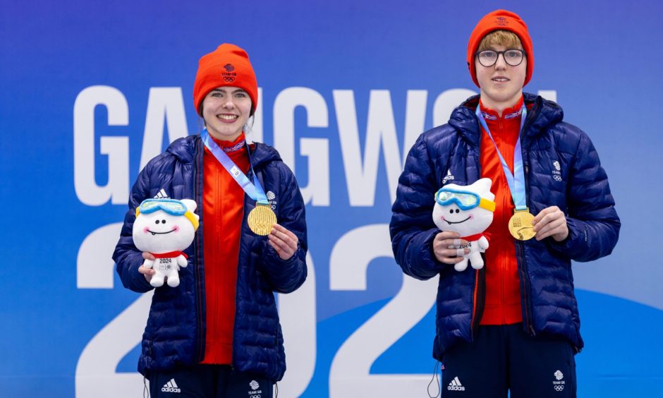 Team GB's Callie Soutar and Ethan Brewster celebrate curling gold on the Gangwon 2024 podium. 