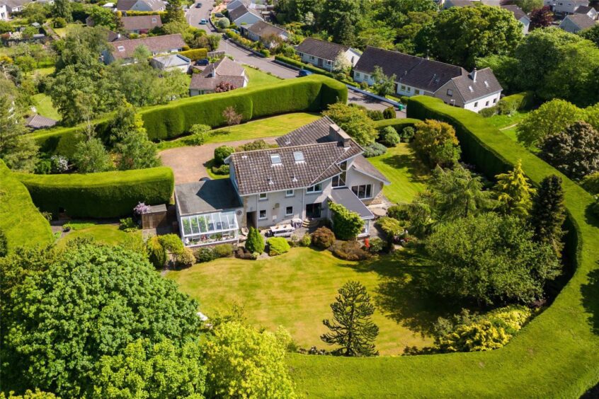 The large hedge provides privacy for the home.