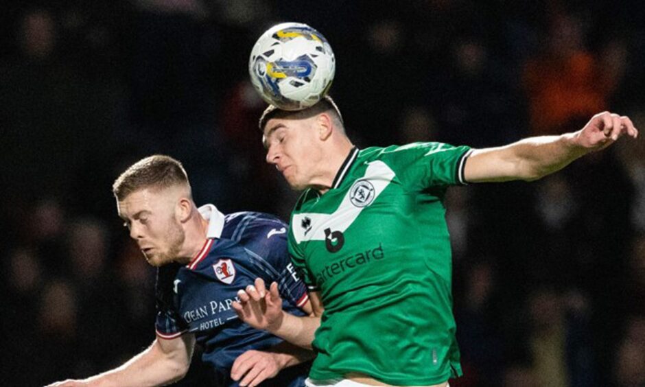 Dundee United defender Ross Graham wins a towering header against Raith Rovers' Callum Smith