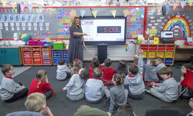 Susie Provan teaches her P1 and P2 pupils on their first day back at Inverkip Primary School in Inverclyde as Scotland's youngest pupils return to the classroom as part of a phased reopening of schools. Picture date: Monday February 22, 2021. PA Photo. Photo credit should read: Jane Barlow/PA Wire