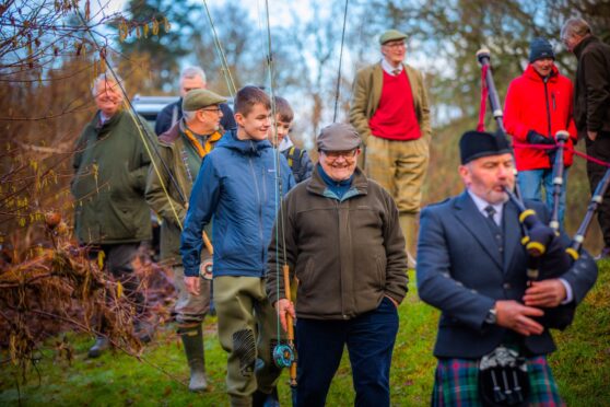 Piper Archie Dick leads the anglers at Inshewan for the  season's first cast. Image: Steve MacDougall/DC Thomson
