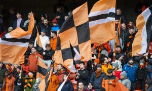 Dundee United supporters wave flags in a Tannadice stand