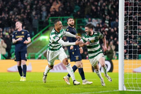 Celtic ran riot against Dundee at Parkhead - Greg Taylor celebrates making it 5-0. Image: PA