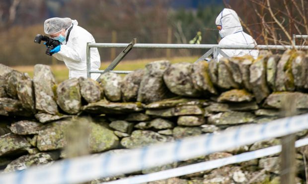 Forensics officers at the scene of the murder of Brian Low.