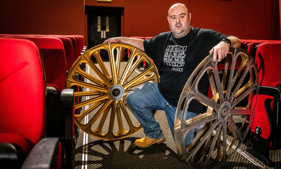 NPH Cinema, St Andrews, technical manager Paul Carey, pictured in December 2021 with some historic memorabilia from when the cinema used film reels and not digital.