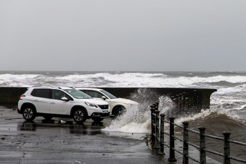 Cars battered by the waves at Leven promenade