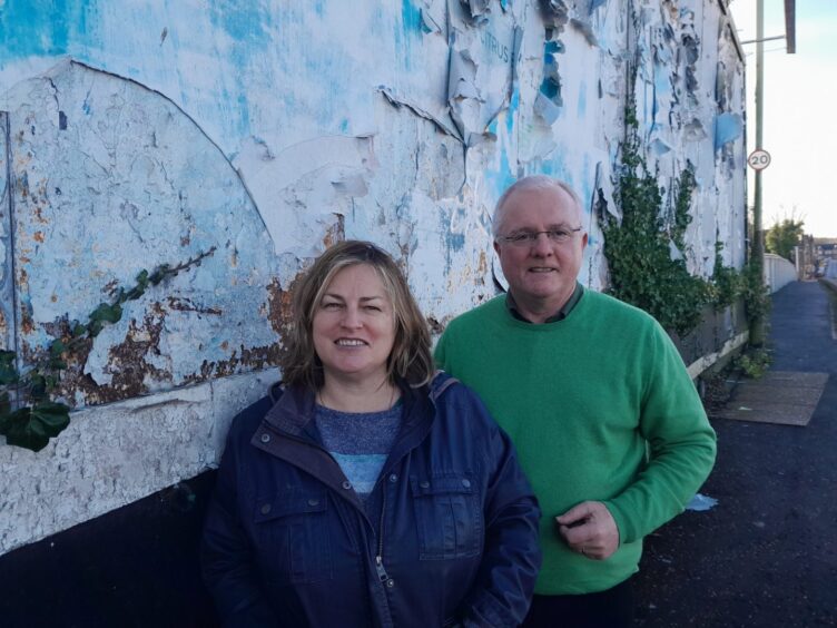 Peter Barrett and Amanda Clark, Lib Dem parliamentary candidate for Perth, standing next to the St Leonard's Bank bridge hoardings.