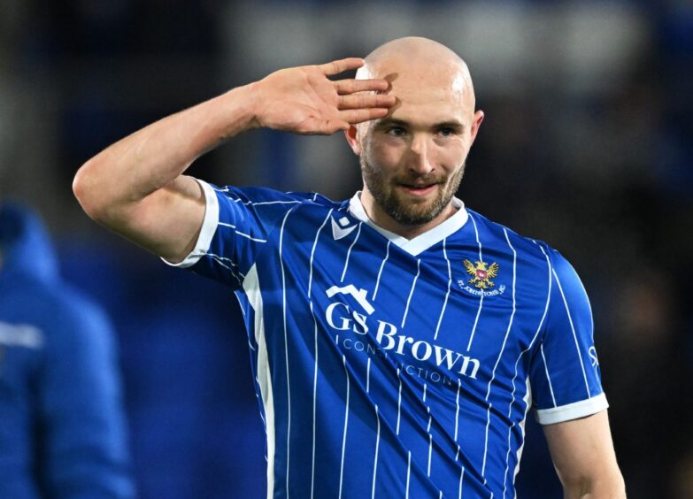 Chris Kane salutes with his right hand during a game with St Johnstone.