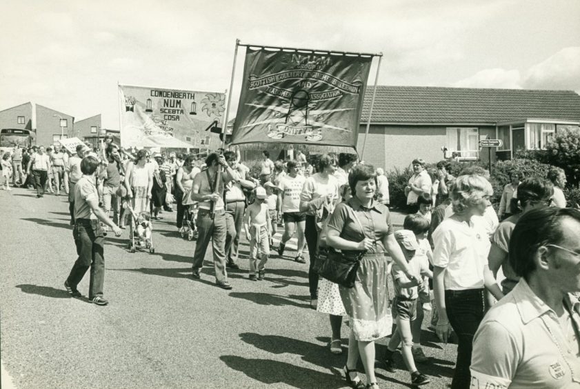 Miners and their families march through Dunfermline in 1984. 